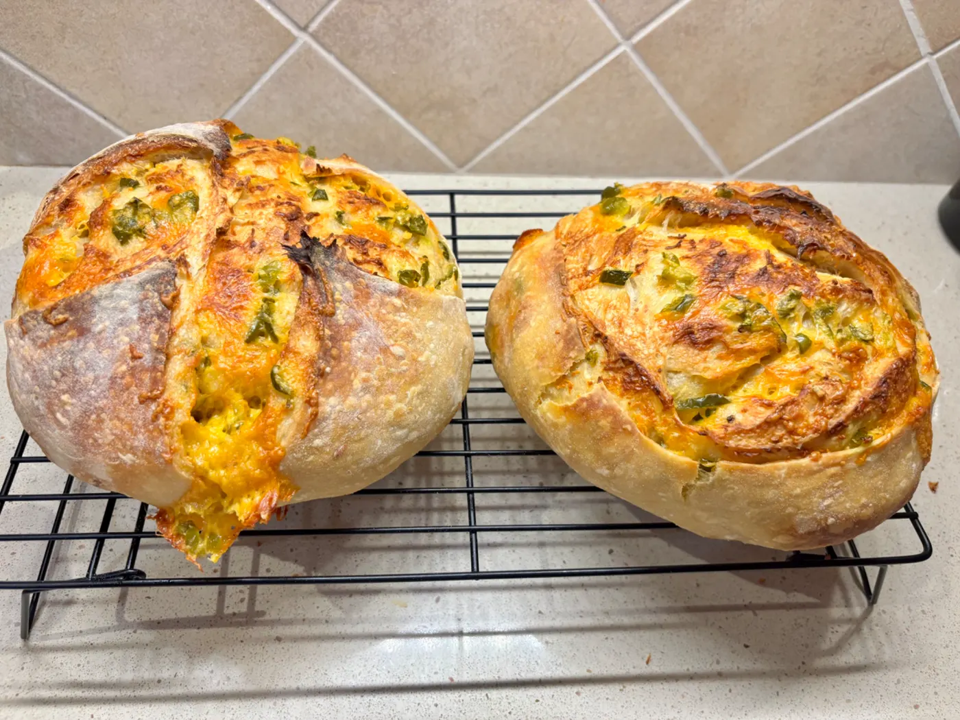 Cheesy artisan sourdough loaf cooling
