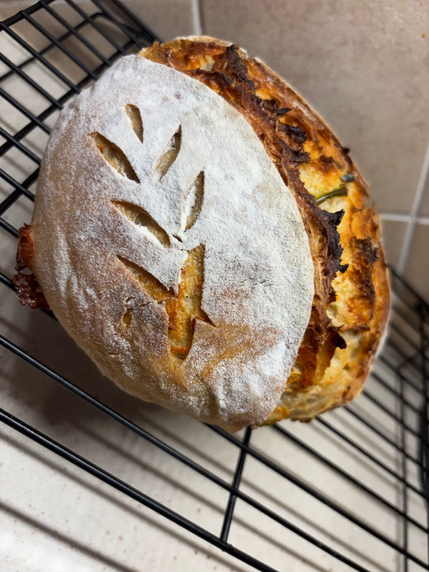 Artisan sourdough loaf with cheese and peppers